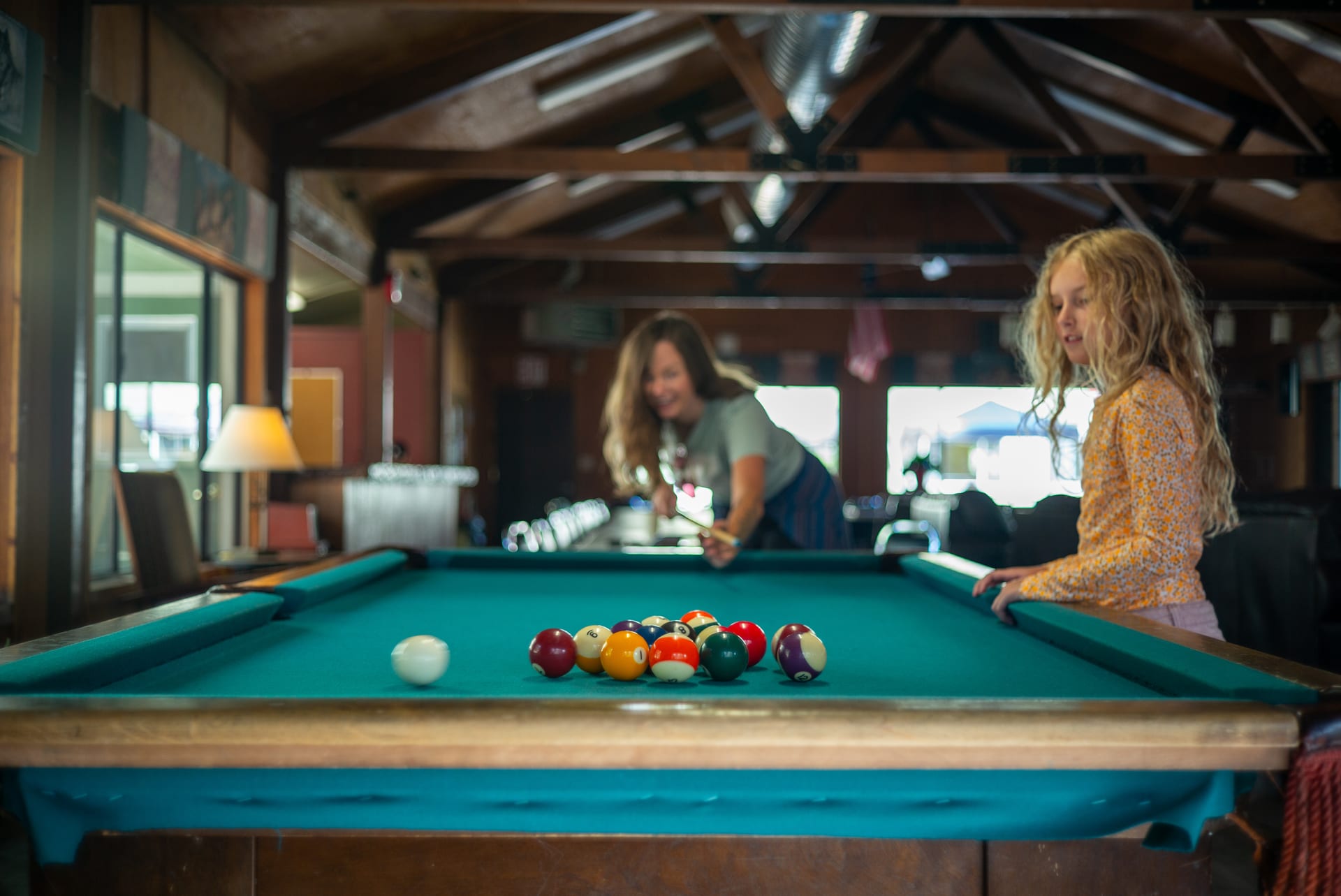 Guests playing pool in the Adult Clubhouse at Outdoorsy Yosemite