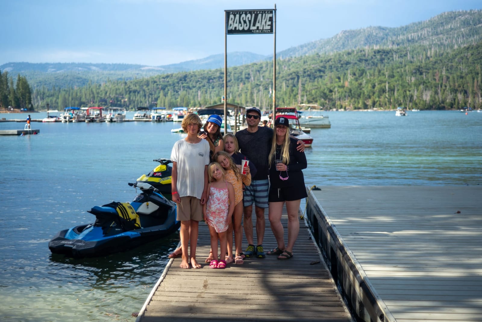 Multi-generational family on the Bass Lake dock, an 8 minute walk from Outdoorsy Yosemite