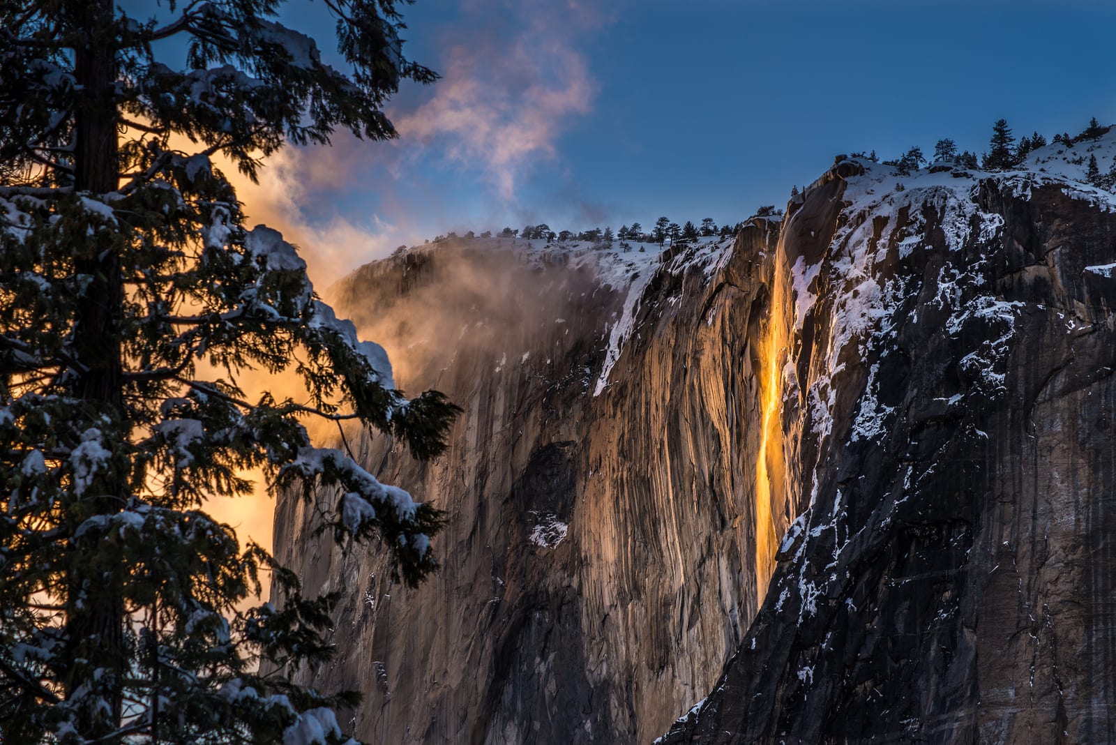 Horsetail Fall "Firefall" glowing orange at sunset over granite cliffs in Yosemite National Park